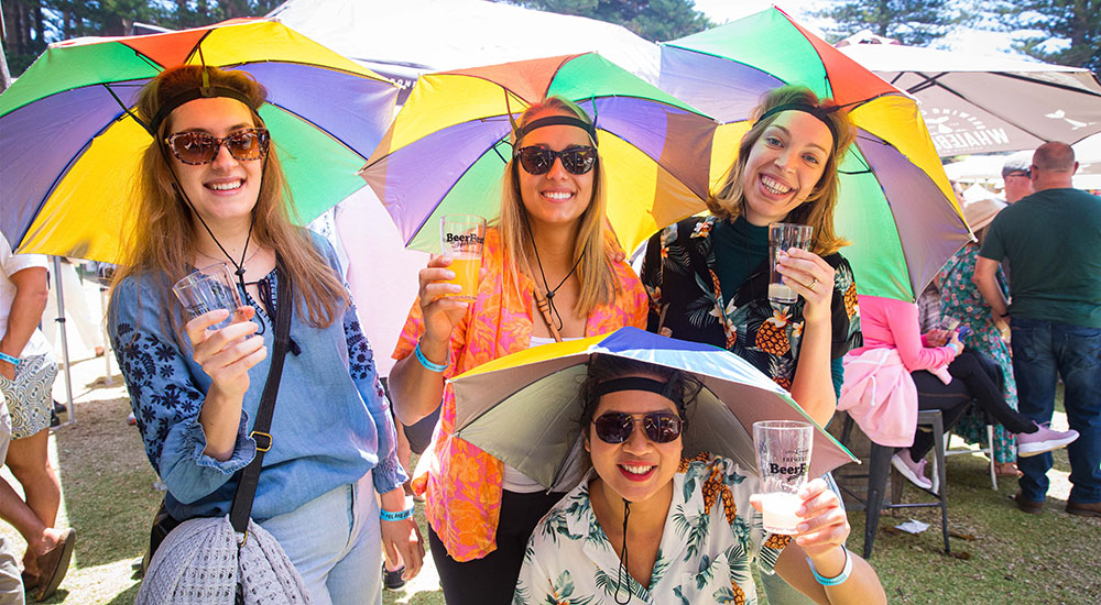 Friends with umbrella hats at BeerFest